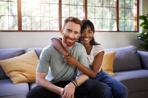 Young couple hugging on couch